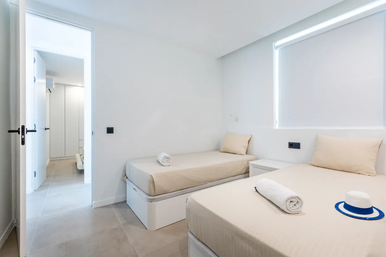 Vista del Silencio - twin-bedroom-with-hallway-view